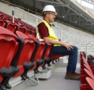 An under-the-seat AP install, with construction worker to show... perspective. Credit: Aruba Networks