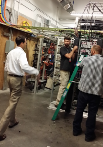 Giants CIO Bill Schlough (left) talks with workers in the park's main DAS head end facility.