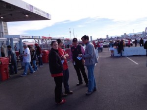 A NiNerd (no vest) helps fans outside the stadium.