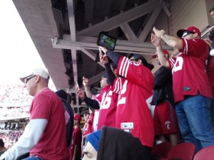 Niners fans get their phone cameras busy for kickoff ceremonies.