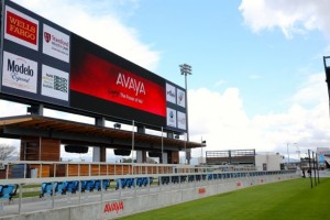 Big scoreboard atop open-air bar area. Sure to be popular, with many beer taps available!