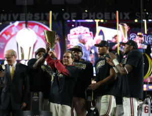 Alabama coach Nick Saban hoists the college championship trophy. Photo by Kent Gidley / University of Alabama