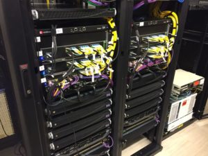 The Wi-Fi backend consists of two ExtremeSwitching bonded S4 Chassis; yellow wires are single-mode fiber optic patch cables and the purple cables are for Wi-Fi infrastructure. Credit: Buffalo Bills / Extreme