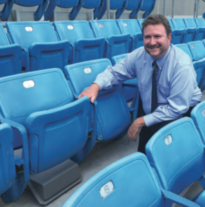 Carolina Panthers director of IT James Hammond shows off a new under-seat Wi-Fi AP at Bank of America Stadium. Credit: Carolina Panthers